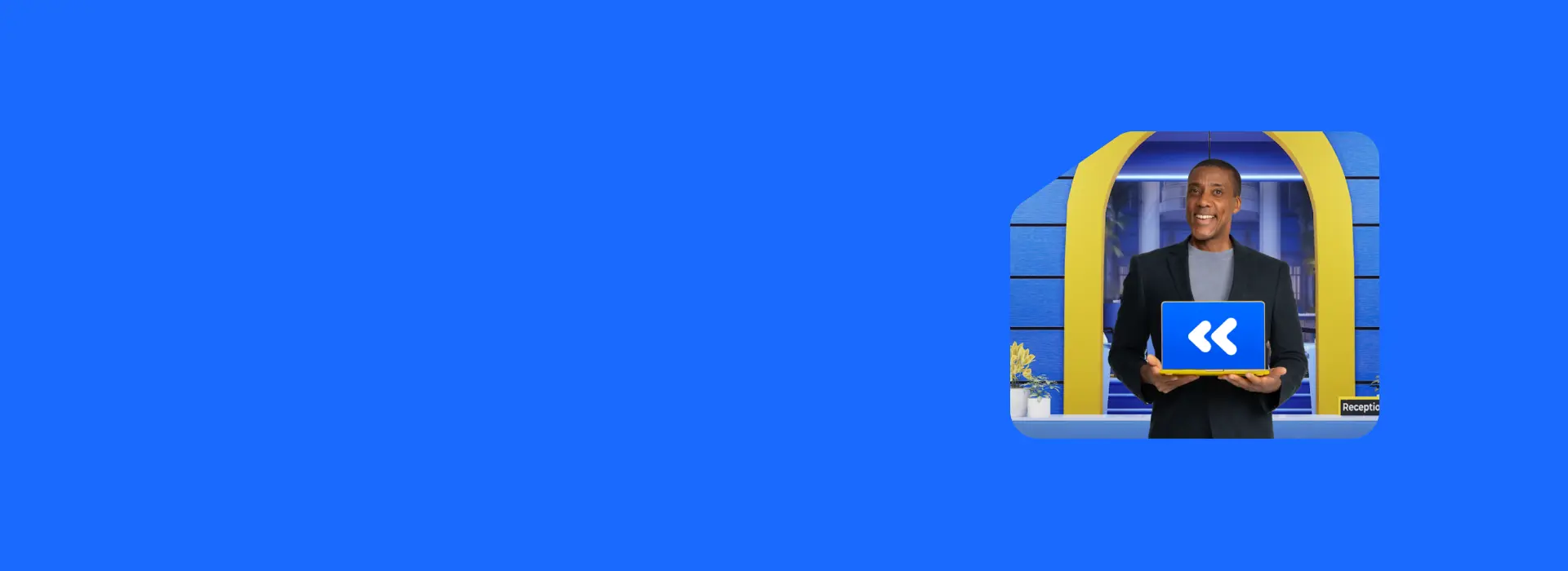 Smiling man holding laptop PC that is displaying Carbonite logo.